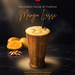 Brass container glass of Mango Lassi by Anmol Sweets sTockholm with fresh mangoes