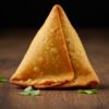 Anmol Chicken Samosa standing on Table.